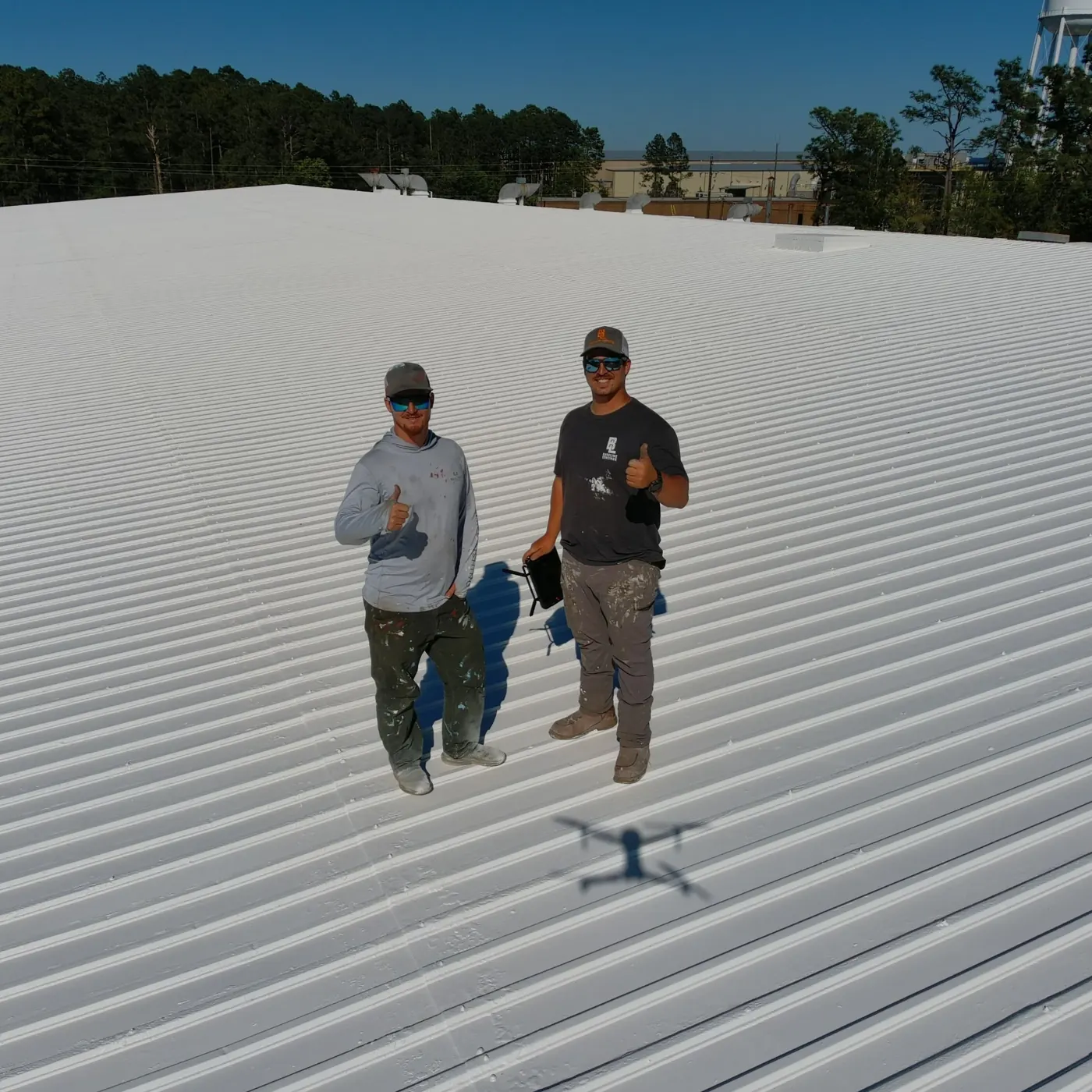 Baseline Coatings crew on completed white roof coating project